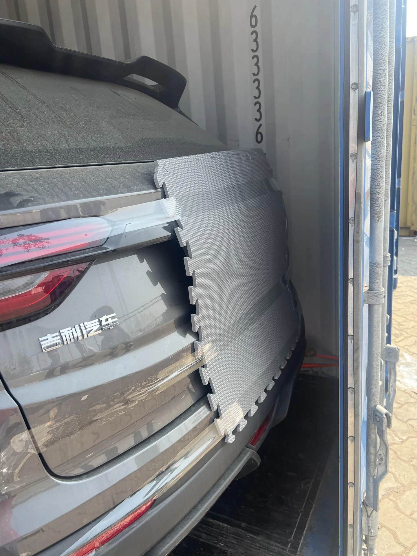 Geely vehicle positioned inside a shipping container