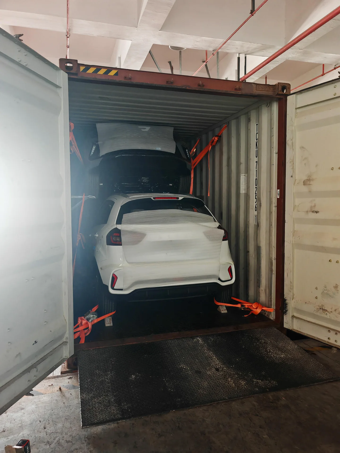 Multiple vehicles loaded and secured for container shipping