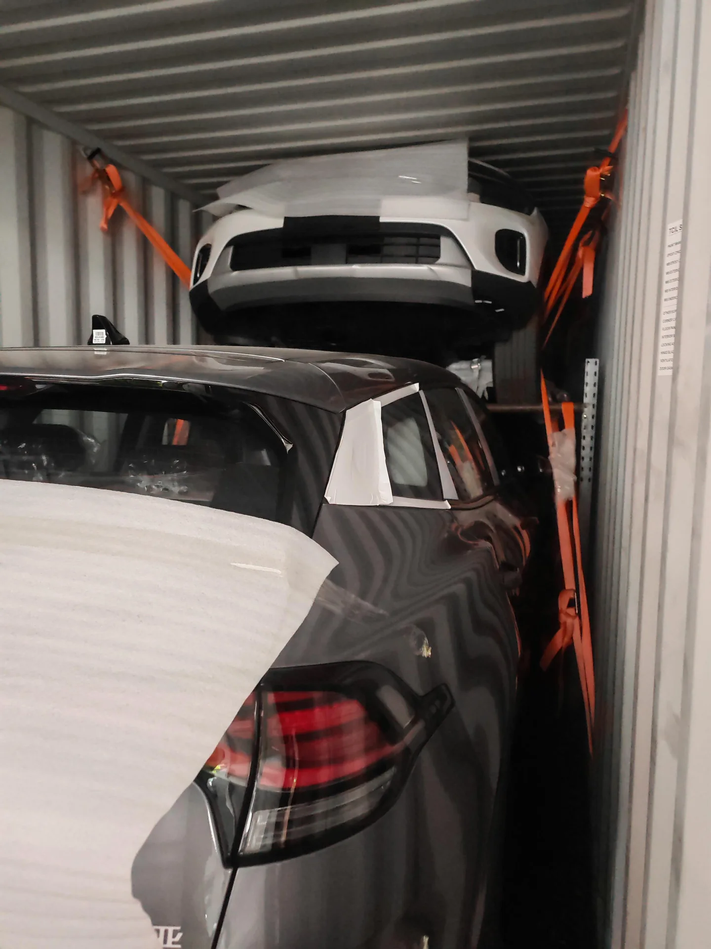 Vehicles secured with protective materials inside a shipping container