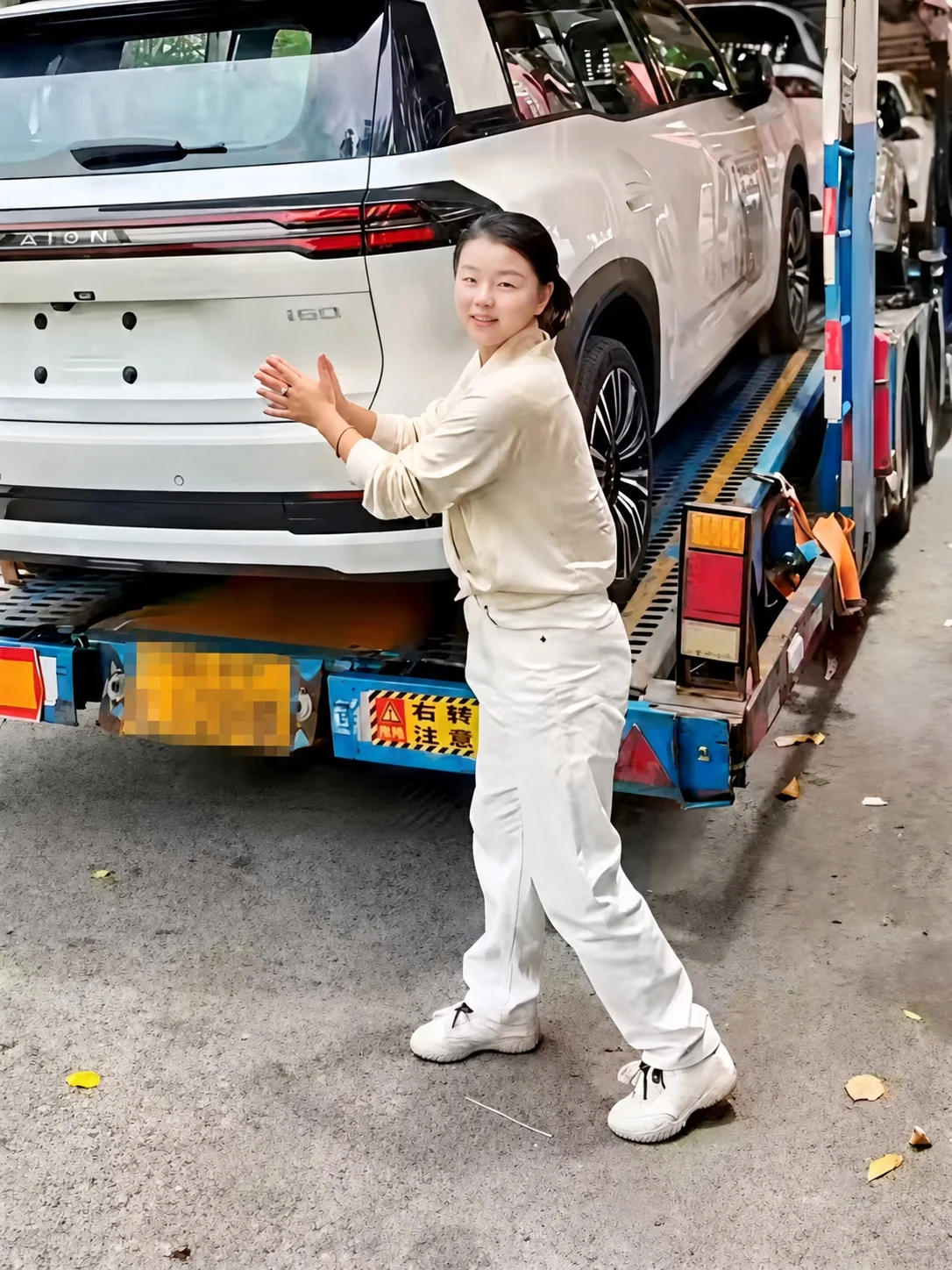 Lillian beside vehicles prepared for sourcing and transport in China