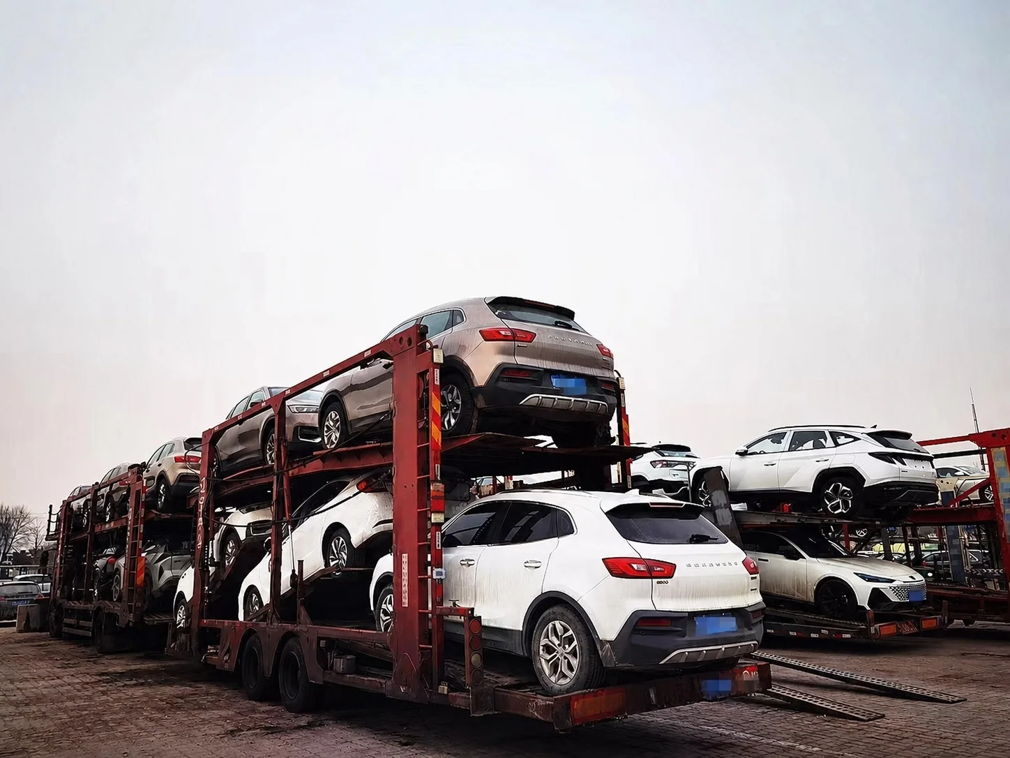Vehicles prepared for transfer on car carrier trucks