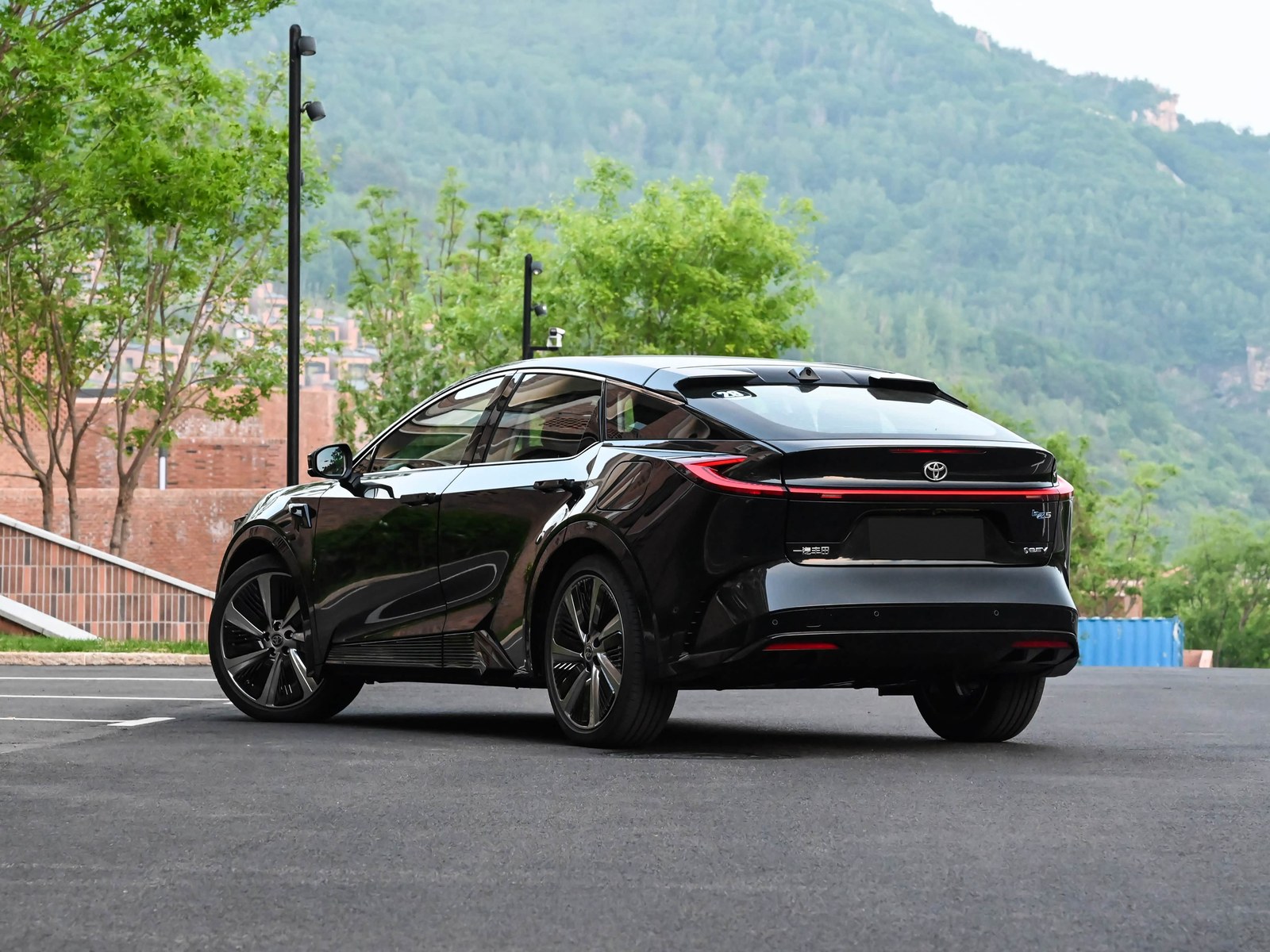 Rear three-quarter view of the black Toyota bZ5 electric SUV