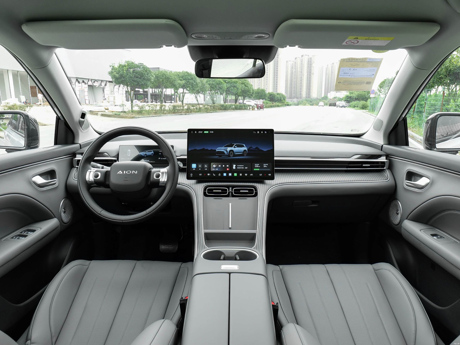 Current AION i60 cabin with digital instrument panel and central touchscreen