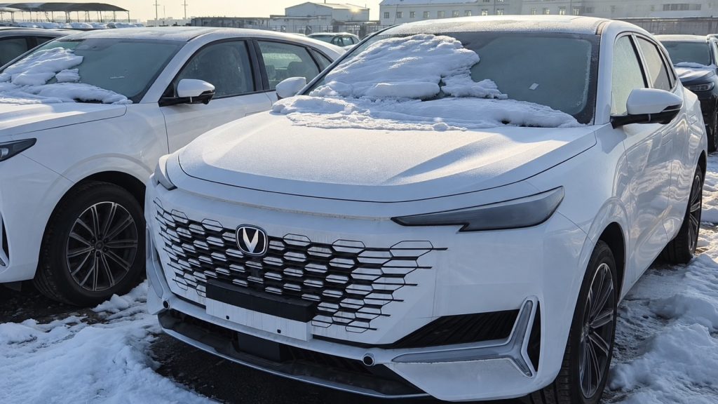 Front view of a white Changan UNI-K in a snowy Horgos vehicle yard
