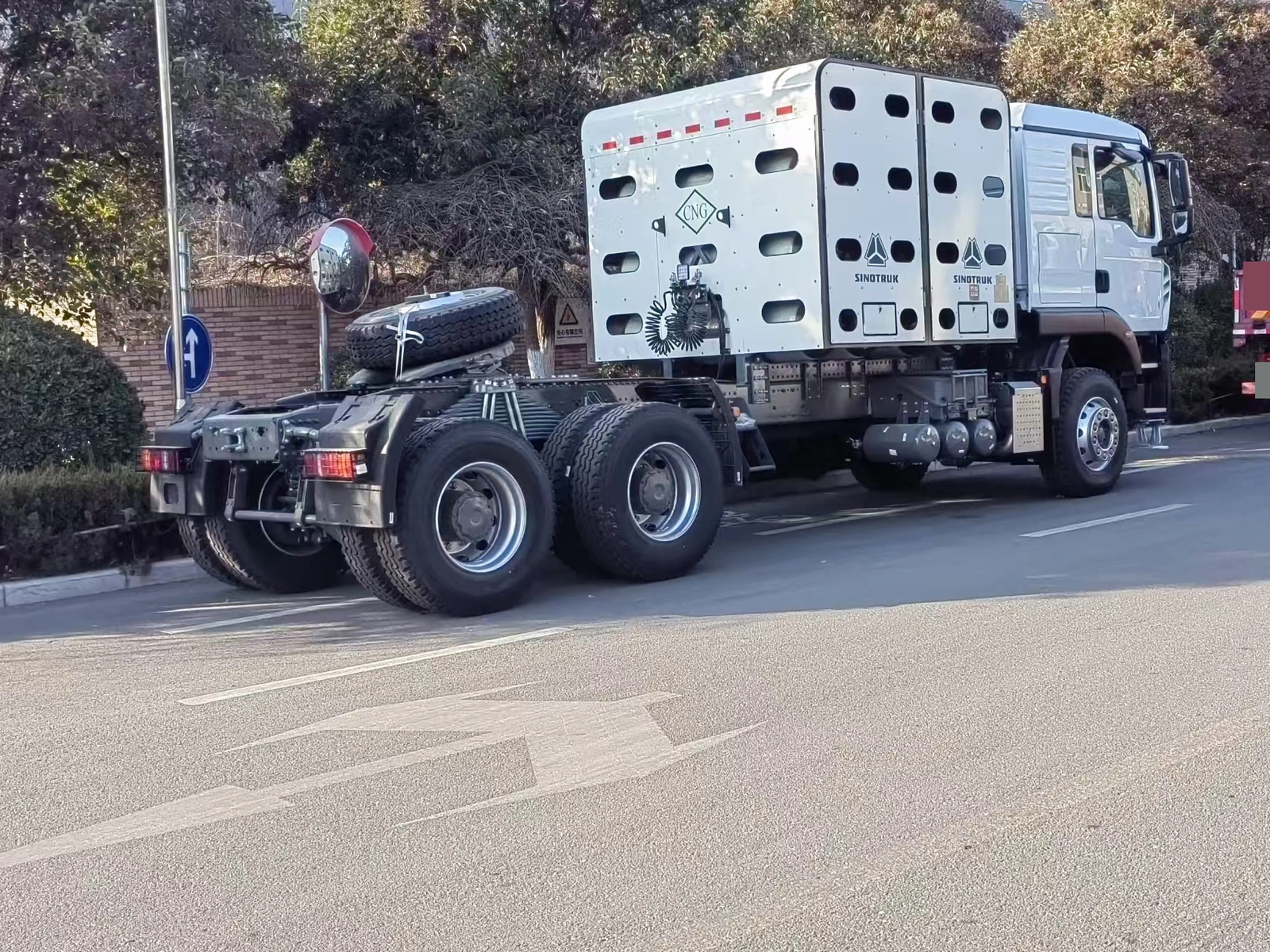 Supplier-provided rear-side view of a white Sinotruk tractor truck with a CNG-marked cylinder enclosure