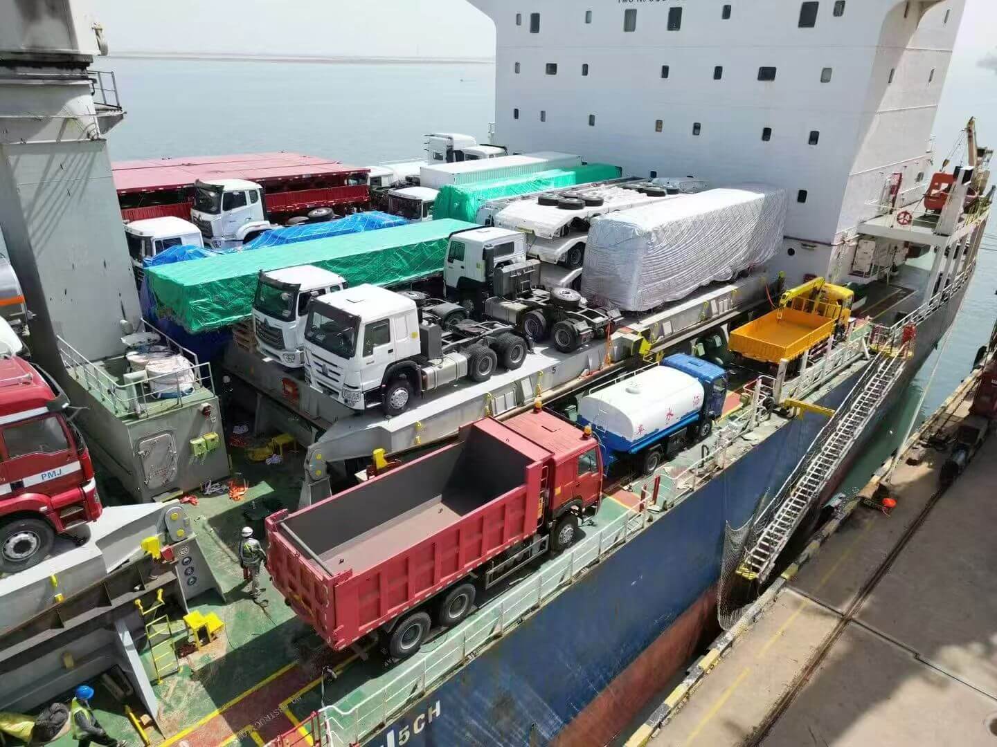 HOWO dump trucks positioned on a cargo vessel for shipment to Tema Port