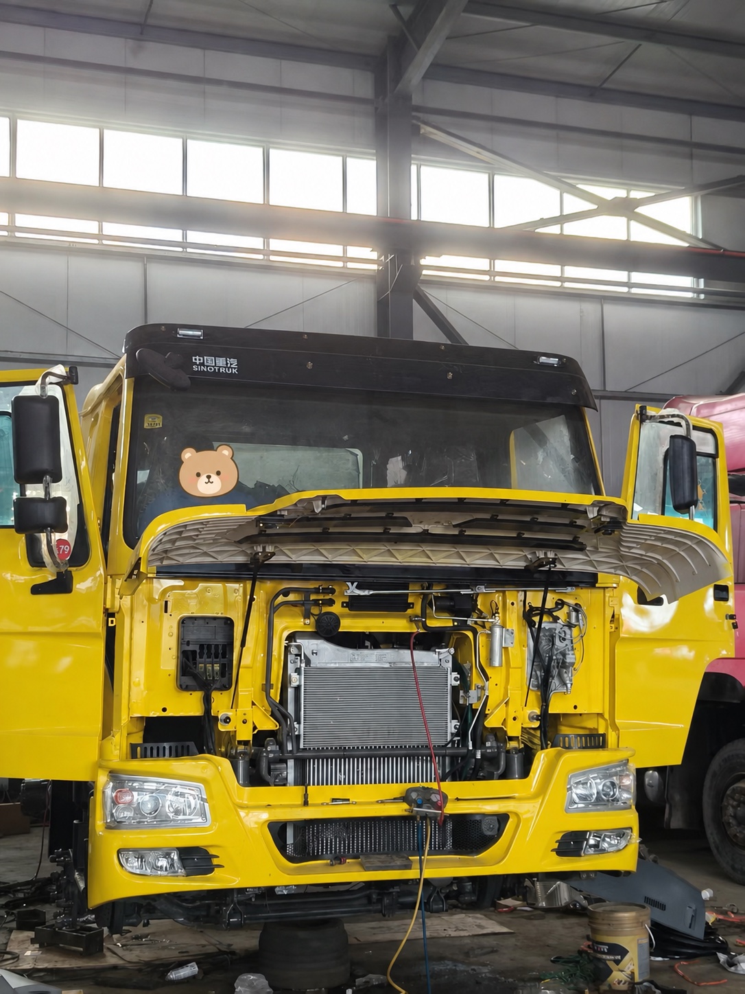 Yellow HOWO truck opened for production and configuration inspection