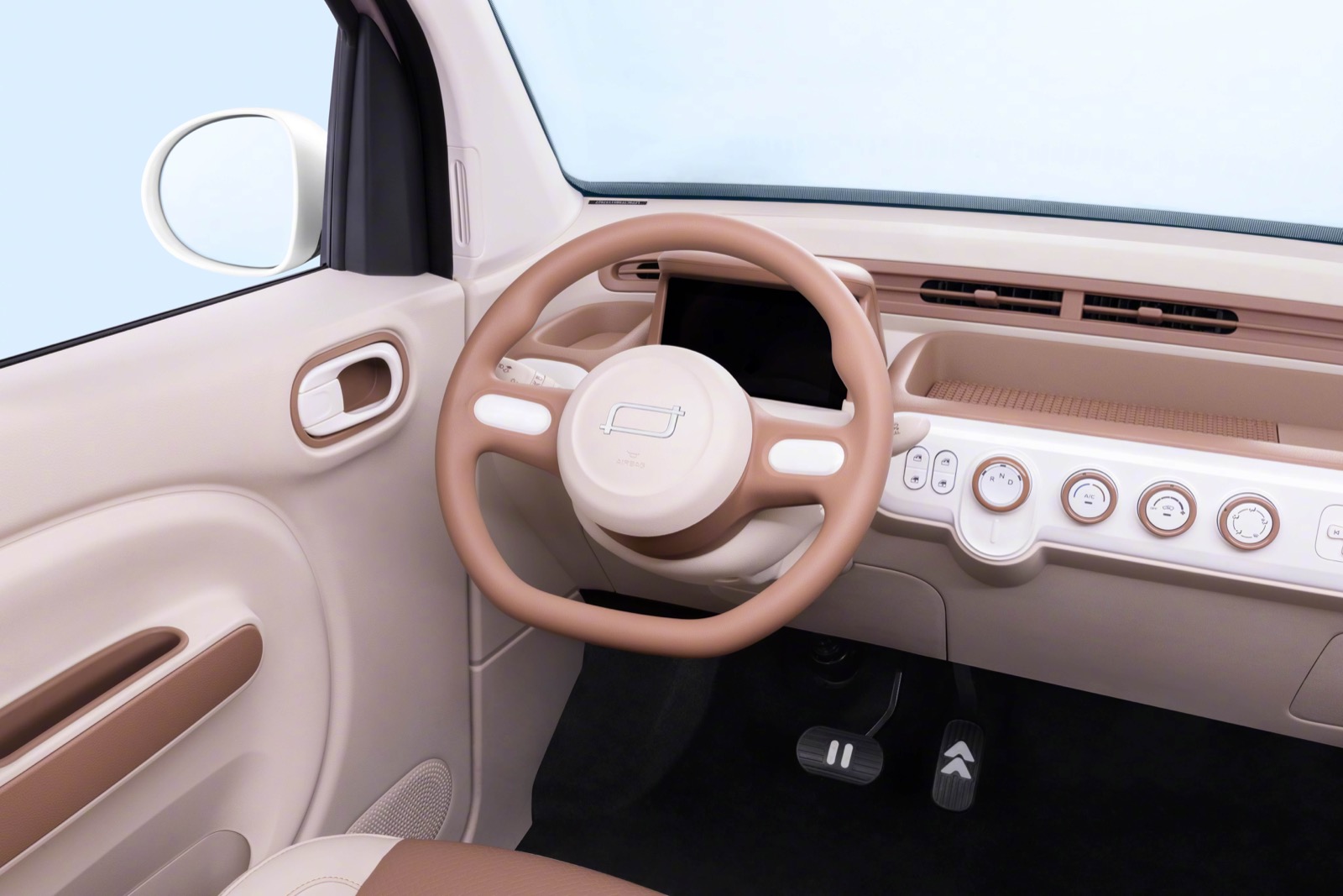 Light brown dashboard and steering wheel inside the Bestune Pony