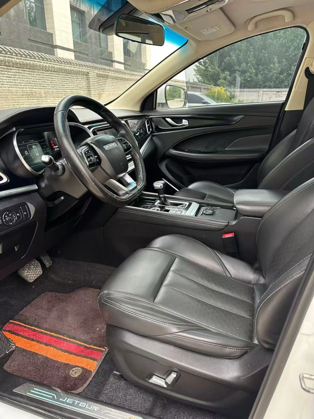 Black front seats, dashboard and driving controls in the 2019 Jetour X90