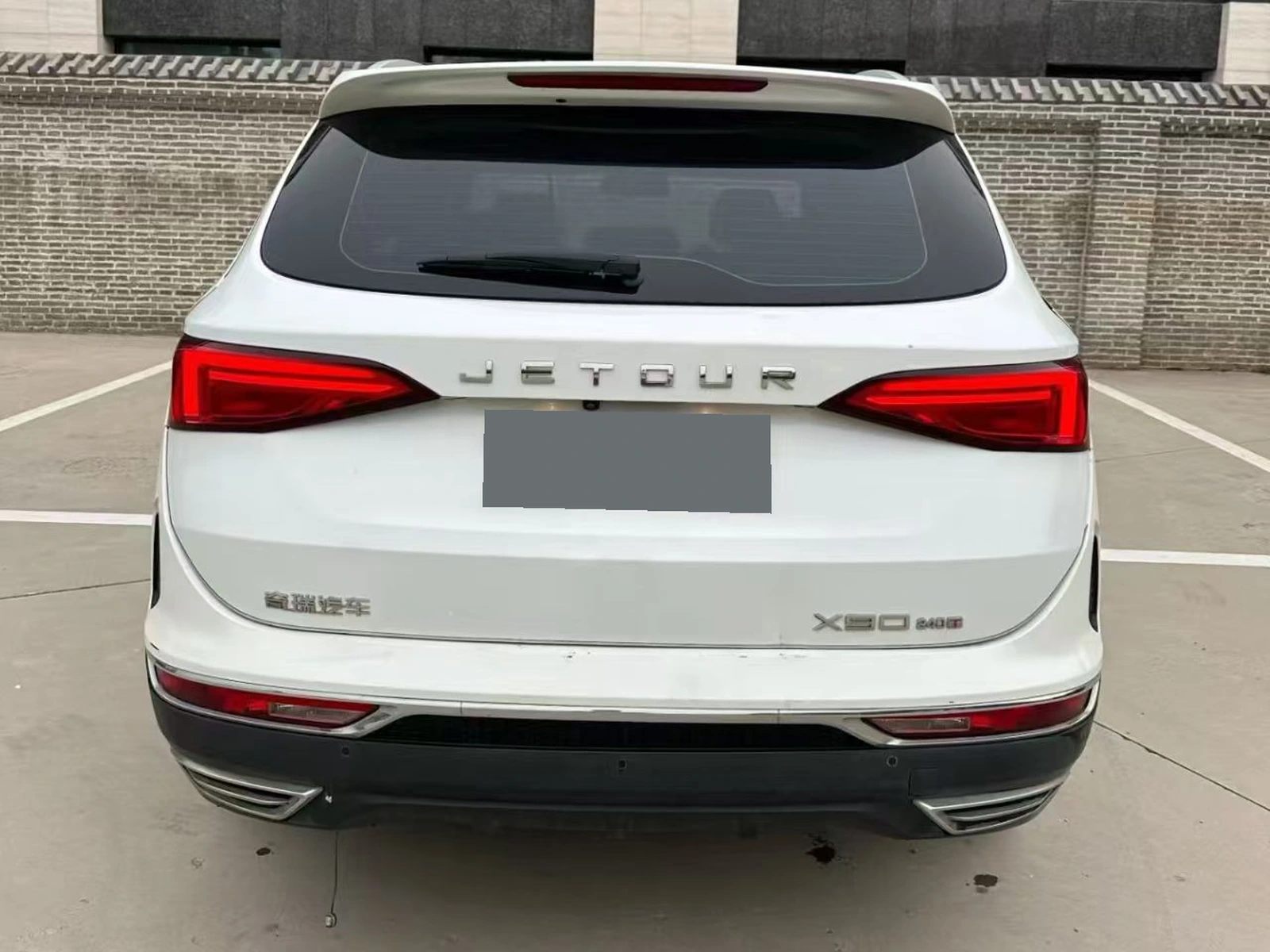 Rear exterior of the white 2019 Jetour X90 with its registration plate obscured
