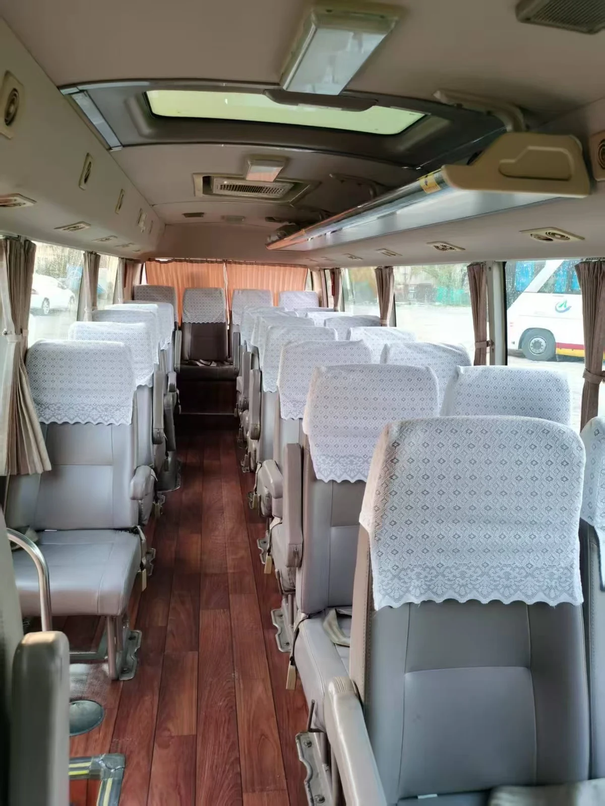 Passenger cabin and seating layout inside a used Coaster-style bus before customisation