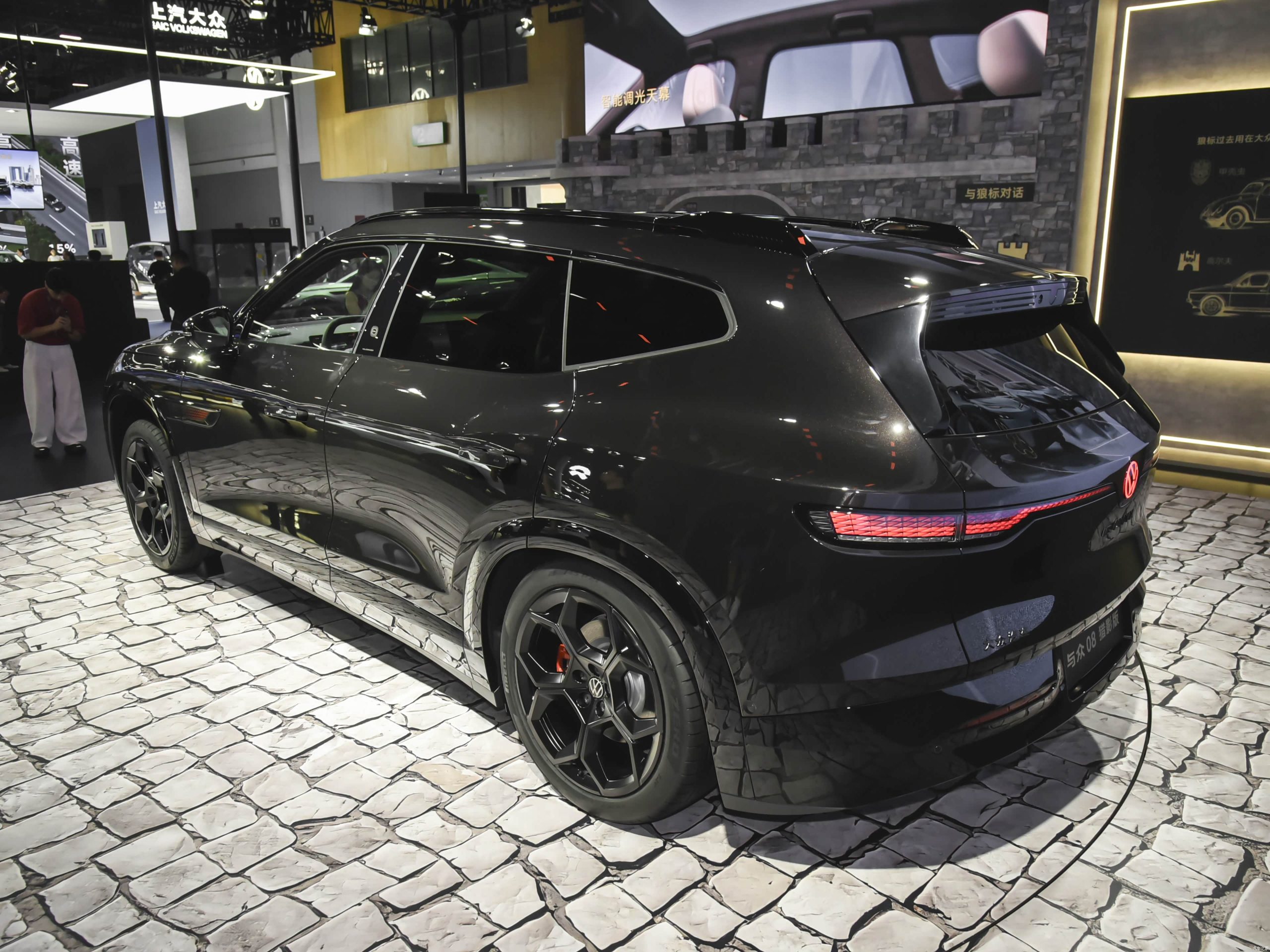 Black Volkswagen ID. UNYX 08 Lieying electric SUV in a rear three-quarter view